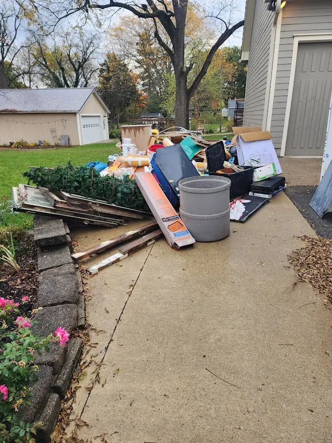 Dumpster being loaded with debris for Commercial Dumpster Rental in Edwardsville